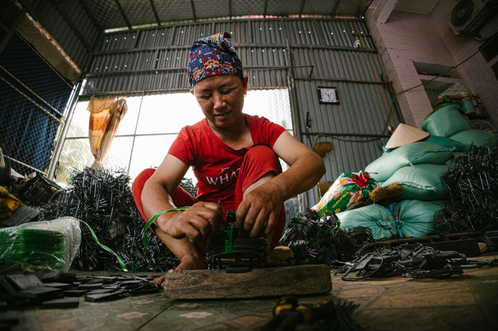 A worker skillfully assembling products in an industrial setting, showcasing skills and dedication.