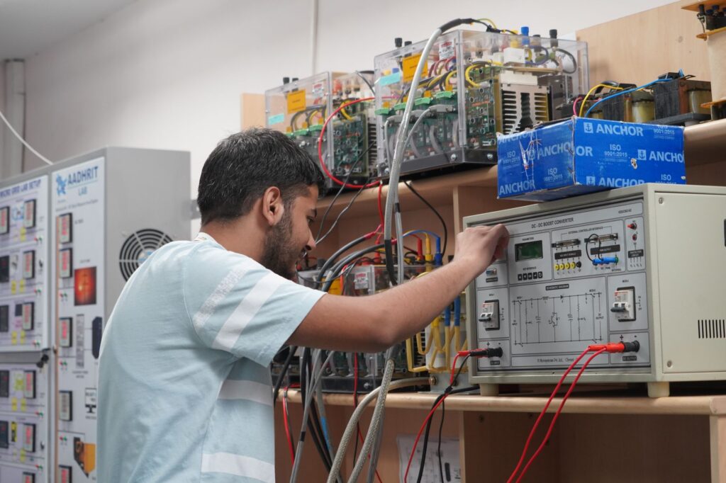 Engineer adjusting equipment in an advanced research lab setting.