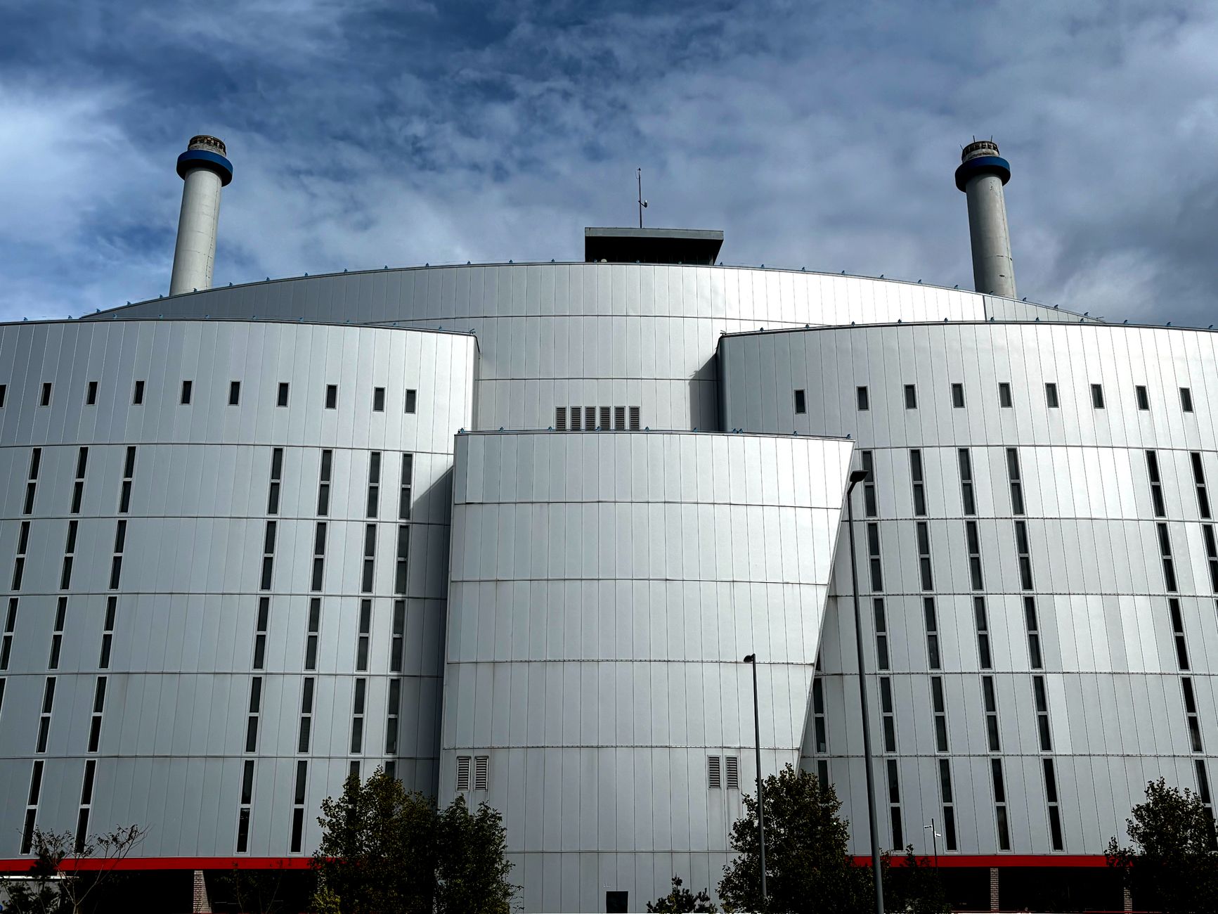 Front view of a modern industrial building with chimneys in Rotterdam.