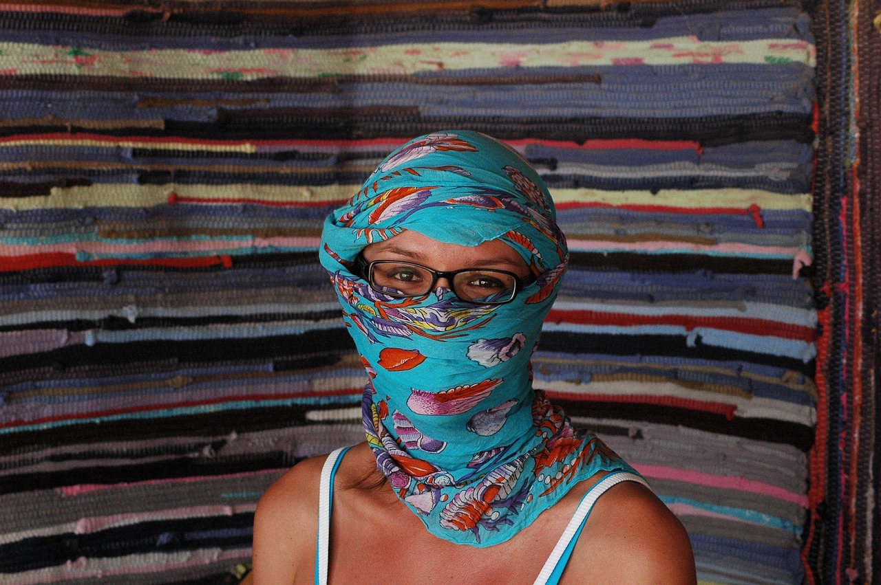 in the desert, a woman, veiled