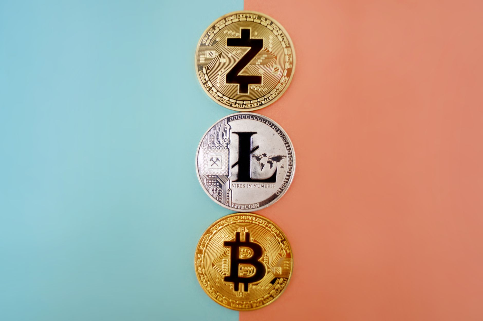 Colorful display of Zcash, Litecoin, and Bitcoin coins on gradient background.